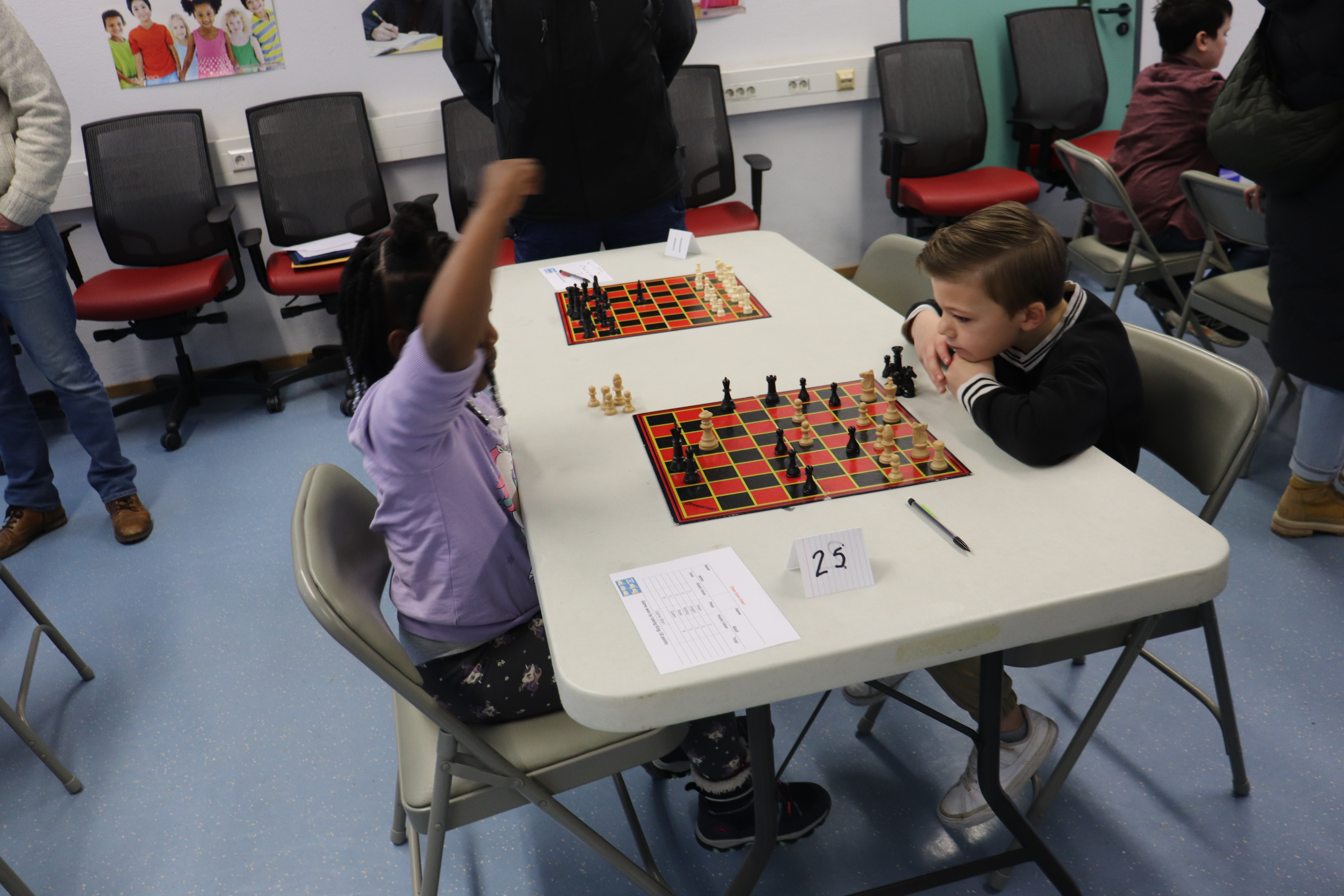 Students engage in a chess match during the fourth annual Chess Tournament.